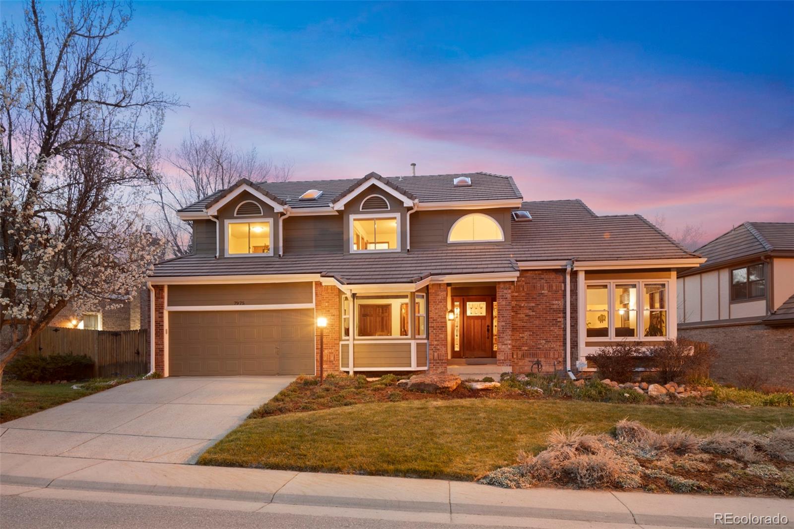 7975 Sweet Water Road Lone Tree, CO 80124 - Photo 1 of 43 front view of a house with a yard