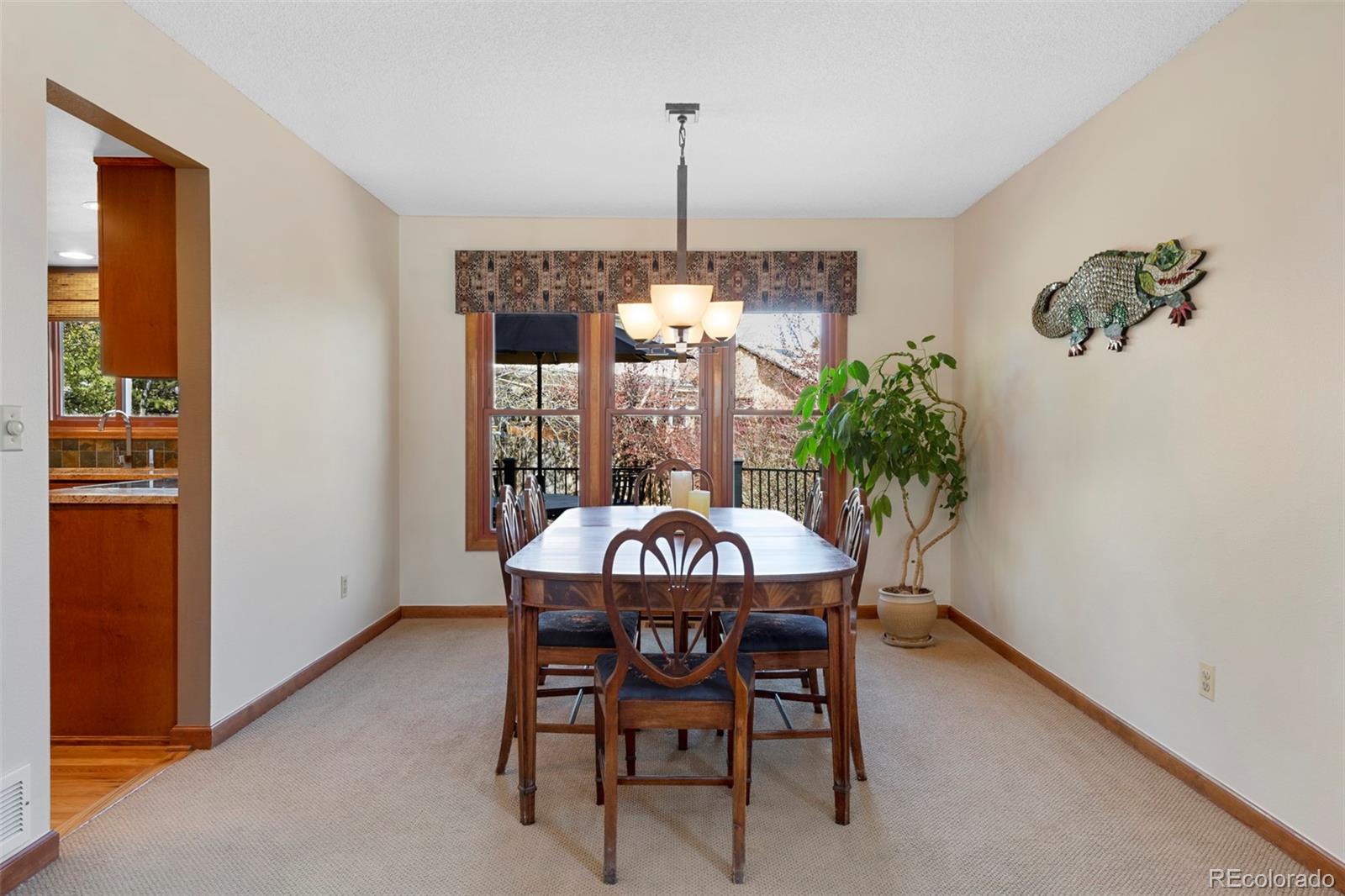 7975 Sweet Water Road Lone Tree, CO 80124 - Photo 11 of 43 a view of a dining room with furniture window and chandelier