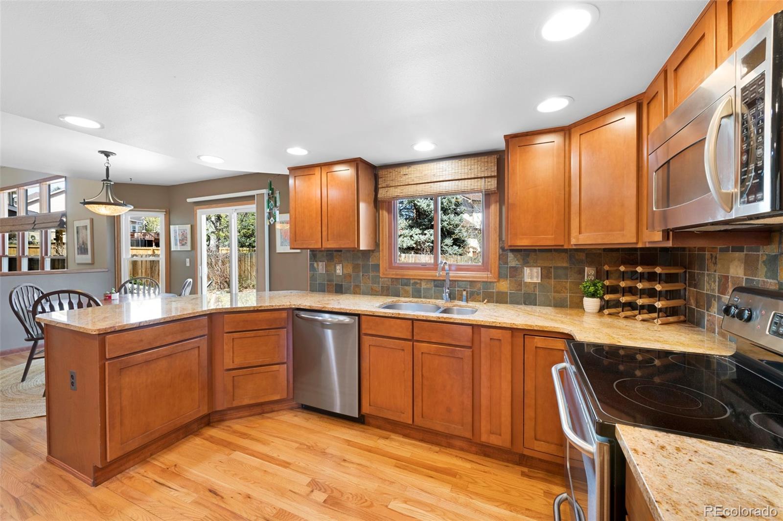 7975 Sweet Water Road Lone Tree, CO 80124 - Photo 12 of 43 a kitchen with a sink stove and cabinets