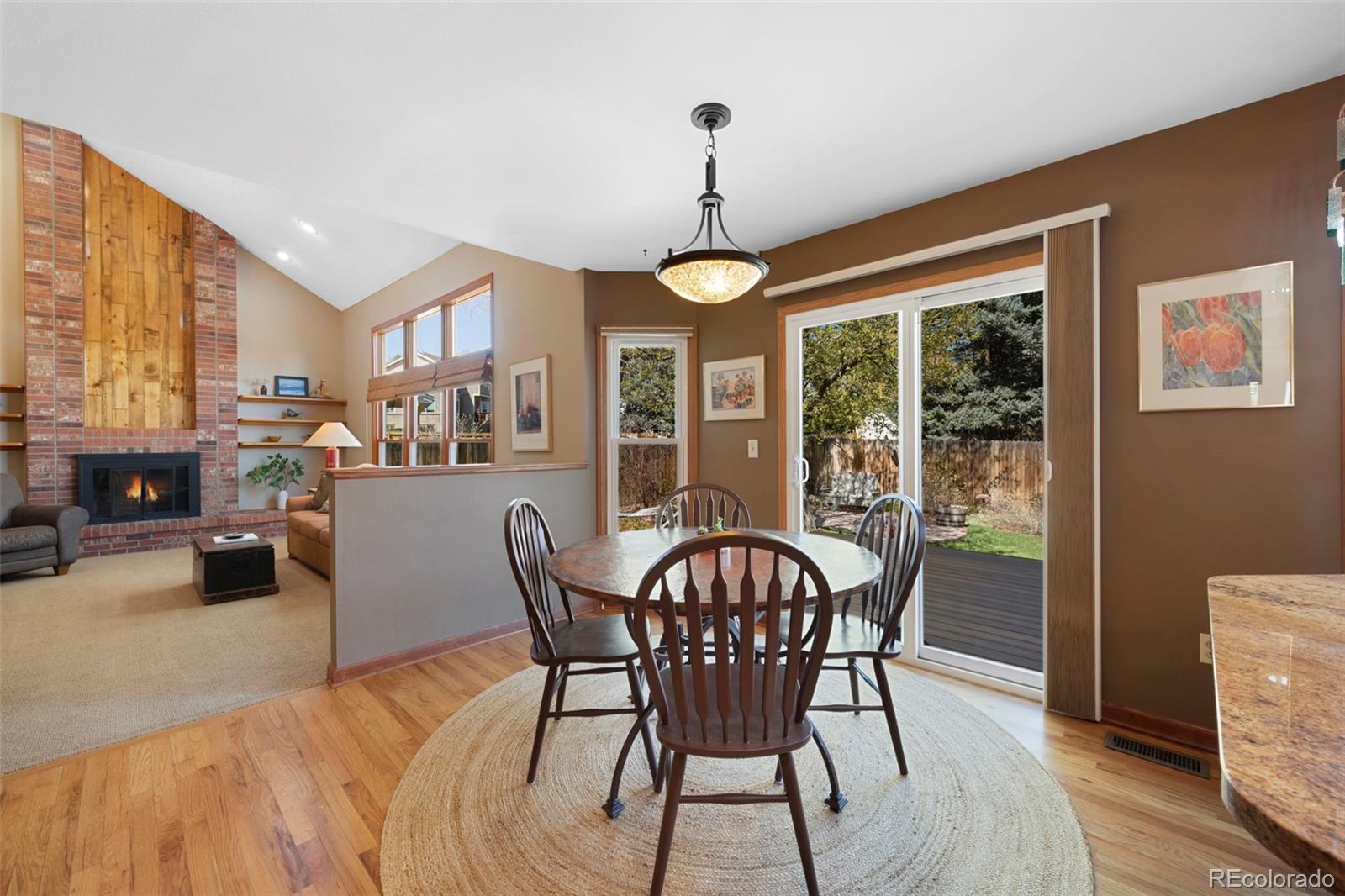 7975 Sweet Water Road Lone Tree, CO 80124 - Photo 15 of 43 a dining room with furniture a chandelier and wooden floor
