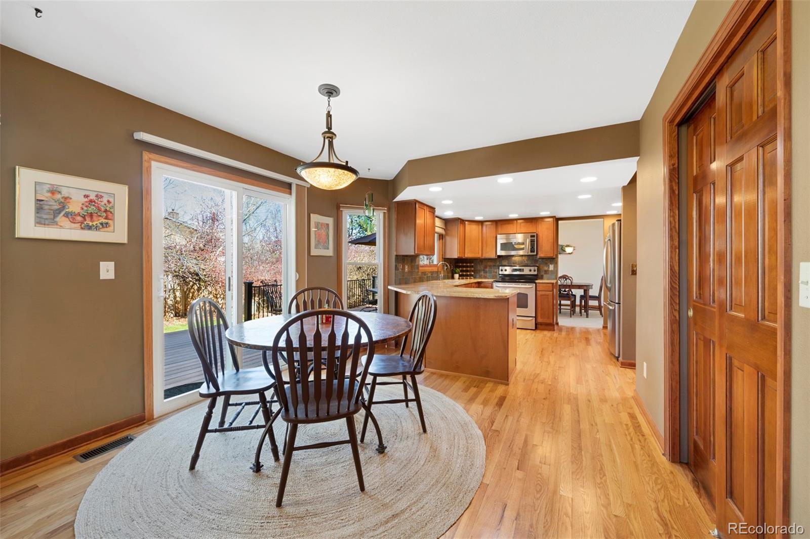 7975 Sweet Water Road Lone Tree, CO 80124 - Photo 18 of 43 a view of a dining room with furniture window and wooden floor