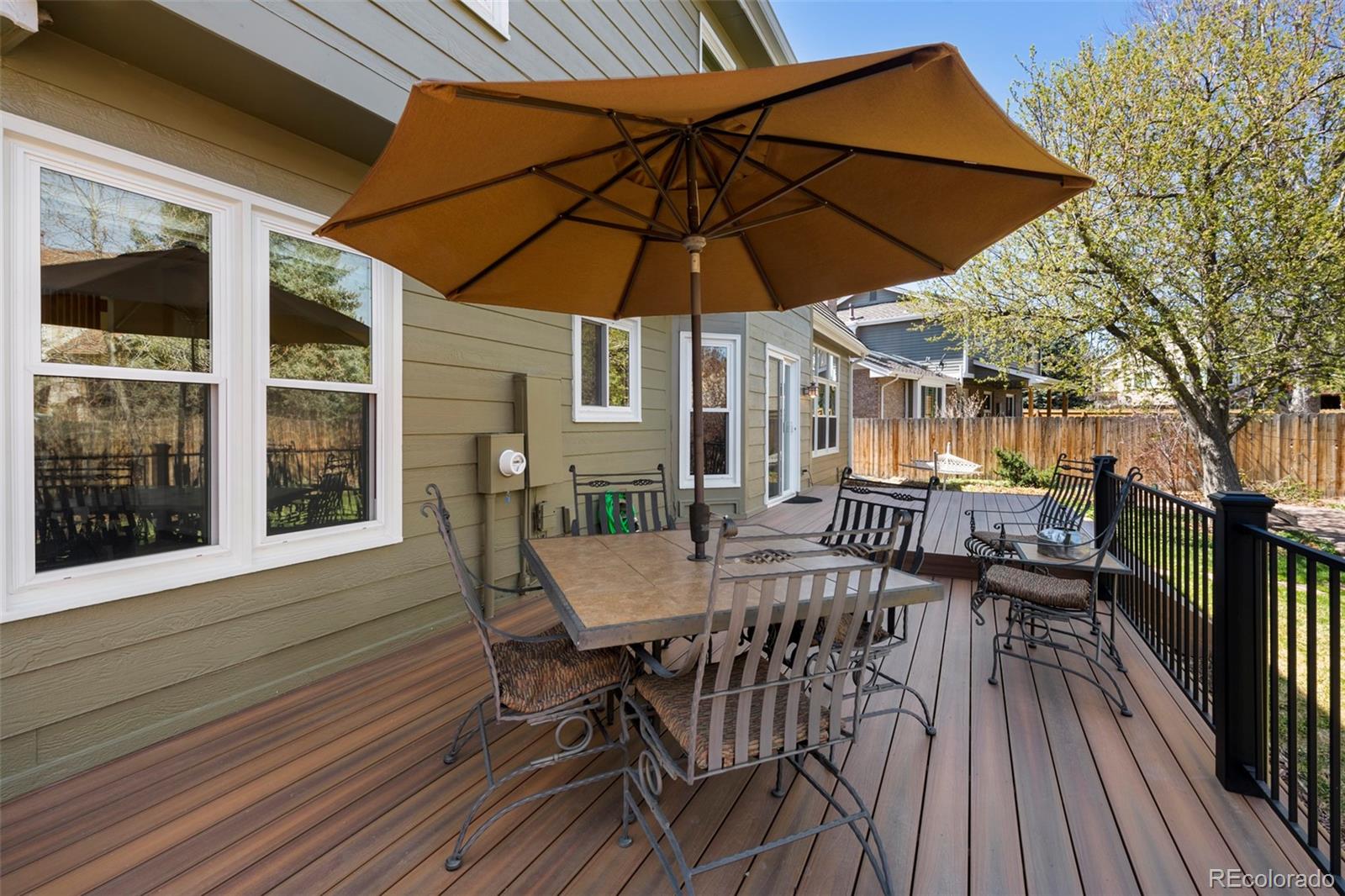 7975 Sweet Water Road Lone Tree, CO 80124 - Photo 21 of 43 a view of a roof deck with table and chairs under an umbrella