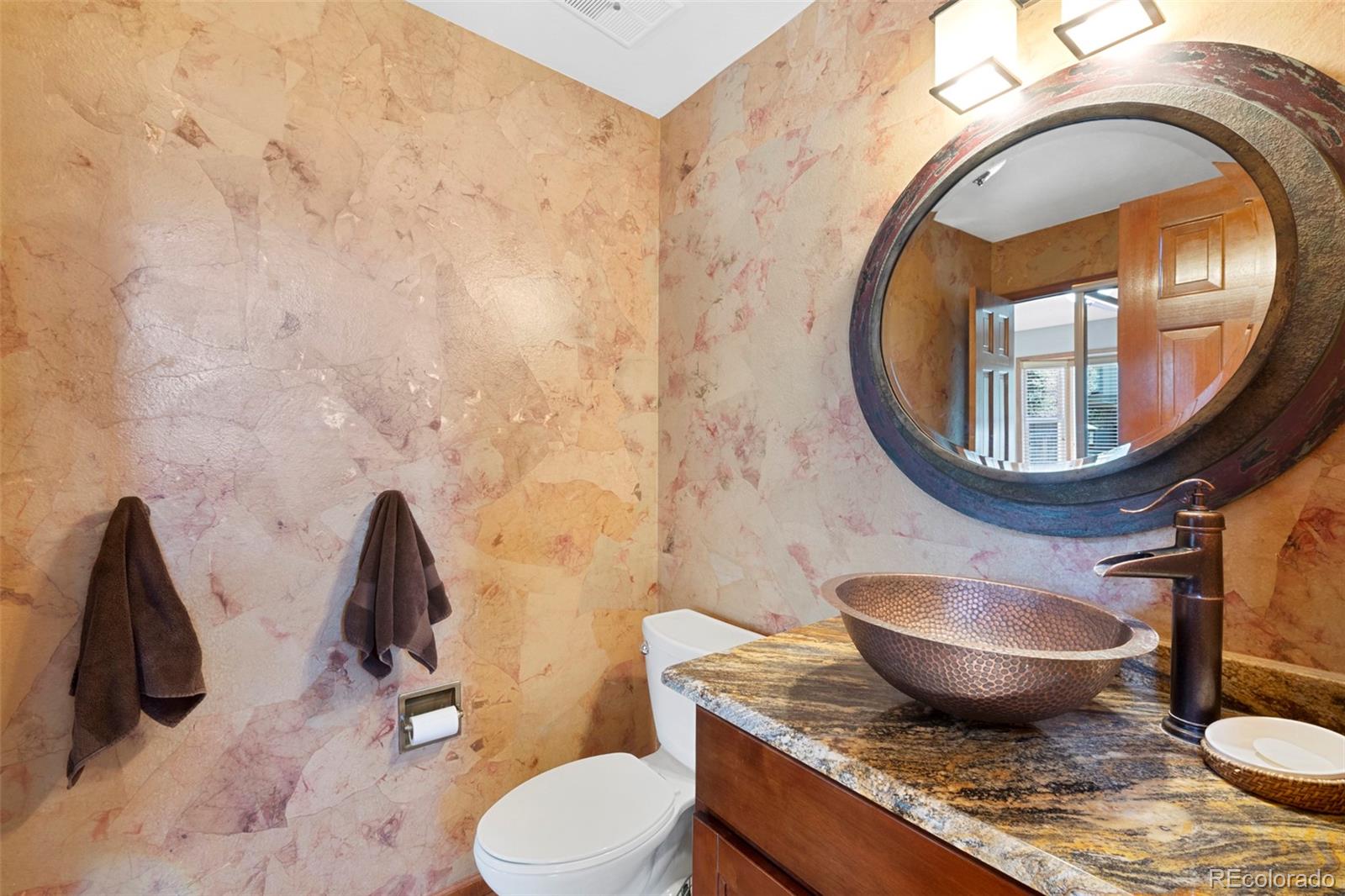 7975 Sweet Water Road Lone Tree, CO 80124 - Photo 22 of 43 a bathroom with a granite countertop toilet sink and mirror