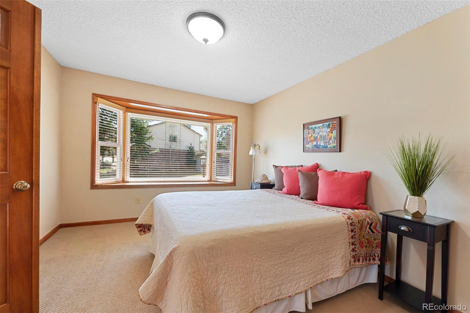 7975 Sweet Water Road Lone Tree, CO 80124 - Photo 24 of 43 a bedroom with a large bed and a large window