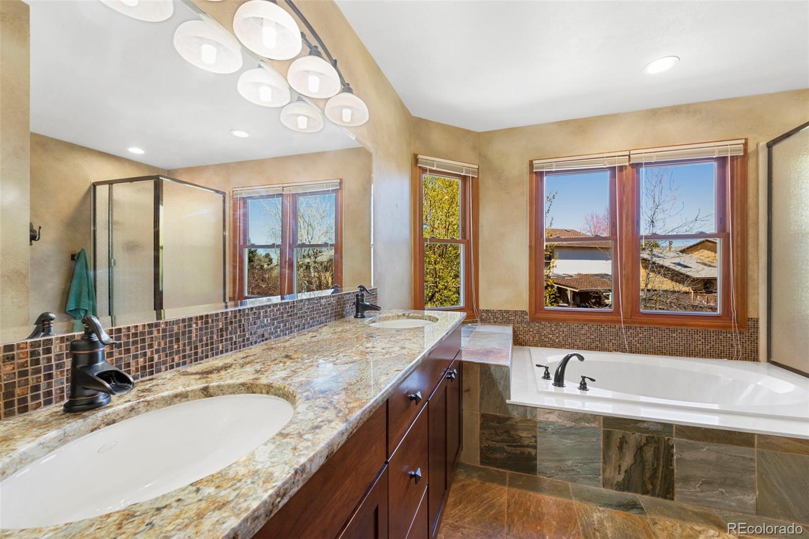 7975 Sweet Water Road Lone Tree, CO 80124 - Photo 28 of 43 a bathroom with a granite countertop sink and a large mirror