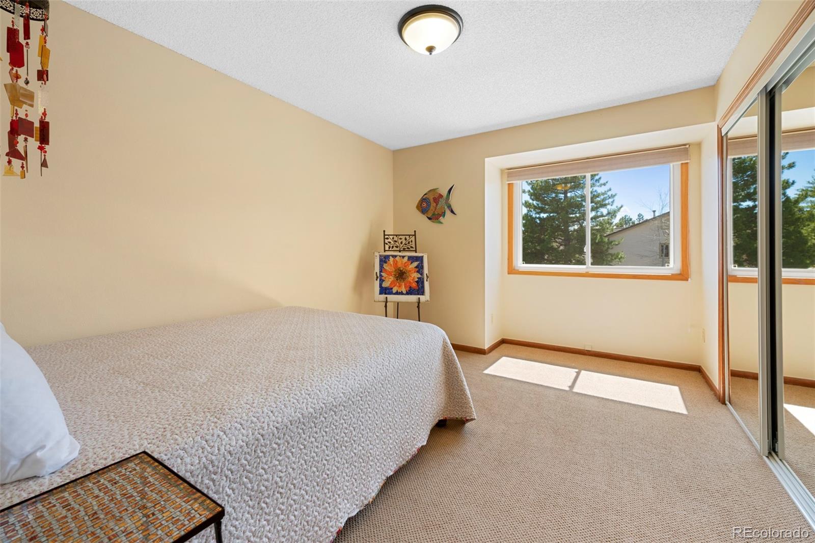 7975 Sweet Water Road Lone Tree, CO 80124 - Photo 30 of 43 a bedroom with a bed and a painting on the wall