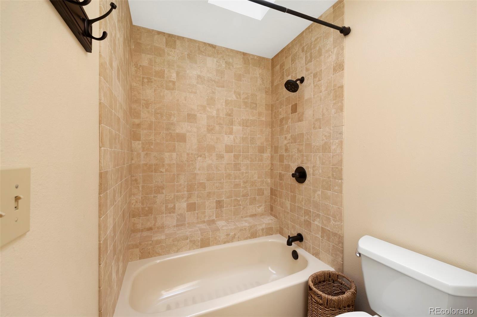 7975 Sweet Water Road Lone Tree, CO 80124 - Photo 32 of 43 a bathroom with a bathtub shower and toilet