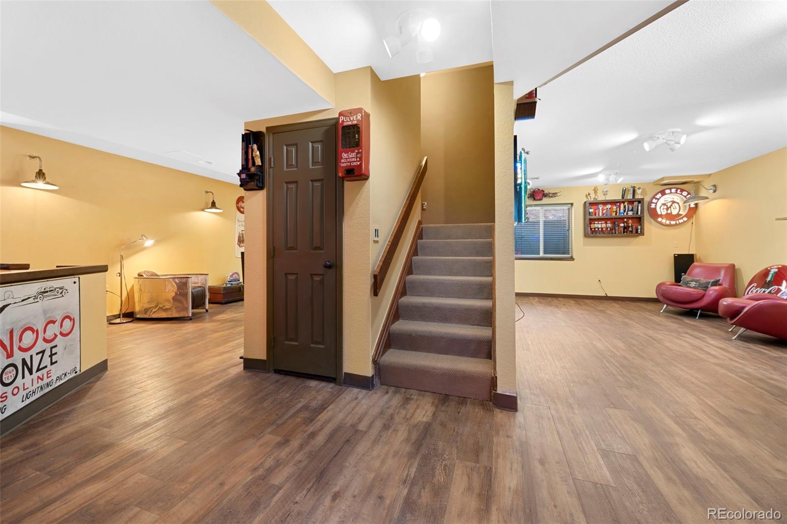 7975 Sweet Water Road Lone Tree, CO 80124 - Photo 34 of 43 a view of a hallway with wooden floor and stairs