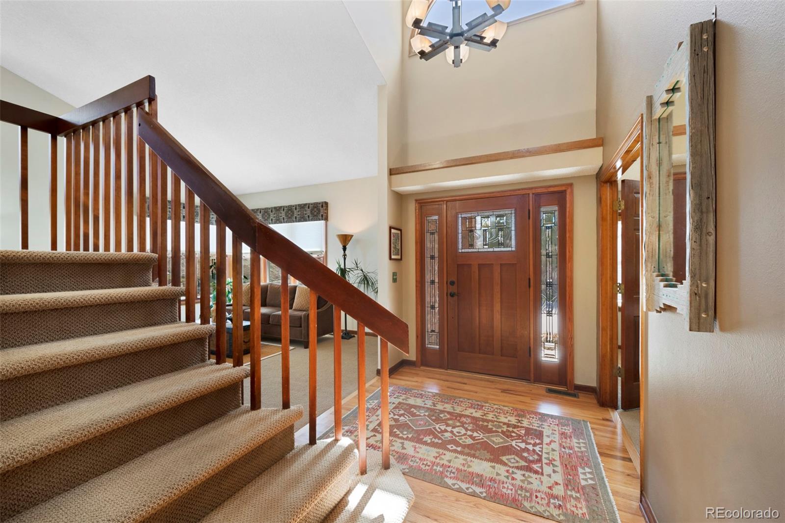 7975 Sweet Water Road Lone Tree, CO 80124 - Photo 6 of 43 a view of a hallway with wooden floor and staircase