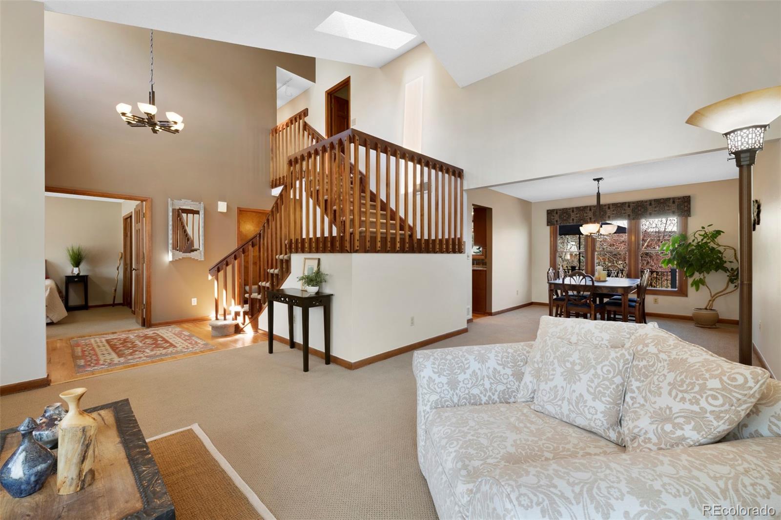 7975 Sweet Water Road Lone Tree, CO 80124 - Photo 10 of 43 a living room with furniture and a chandelier