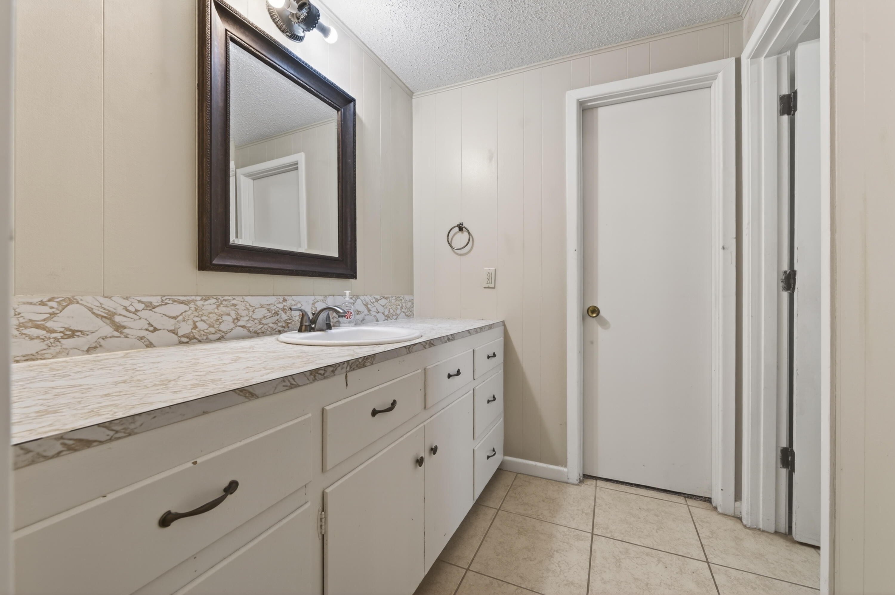 2212 22nd Street Lubbock, TX 79411 - Photo 8 of 14 a bathroom with a granite countertop sink two mirror and a