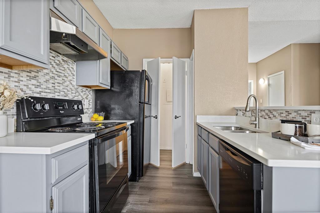 4113 Esters Road, Unit 609 Irving, TX 75038 - Photo 2 of 18 a kitchen with stainless steel appliances granite countertop a sink stove and refrigerator
