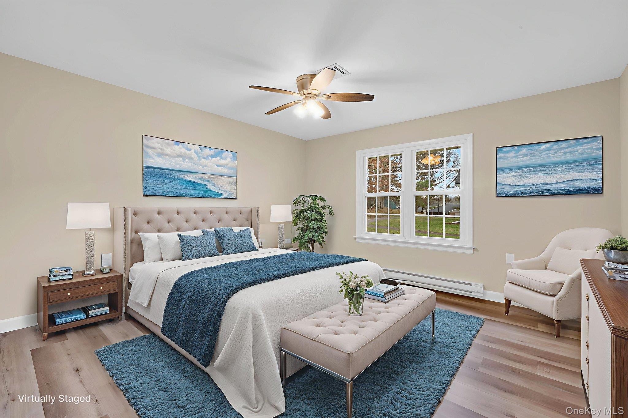 380 Woodbridge Drive, Unit D Ridge, NY 11961 - Photo 11 of 25 a spacious bedroom with a bed couch and a window