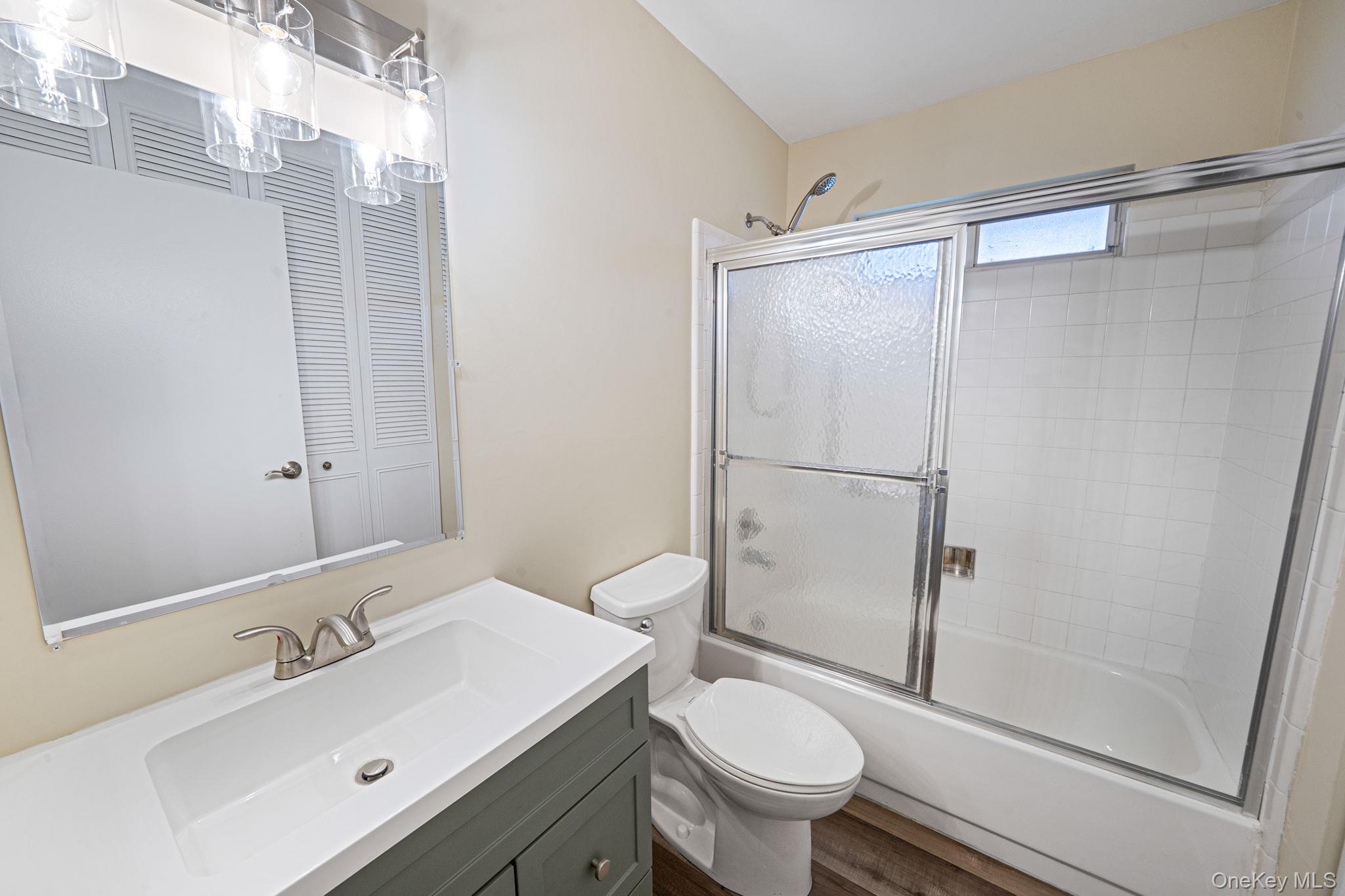 380 Woodbridge Drive, Unit D Ridge, NY 11961 - Photo 12 of 25 a bathroom with a sink toilet and shower