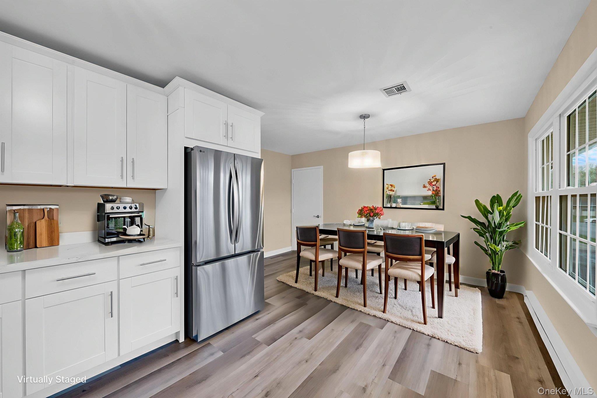 380 Woodbridge Drive, Unit D Ridge, NY 11961 - Photo 5 of 25 a kitchen with granite countertop appliances cabinets and dining table