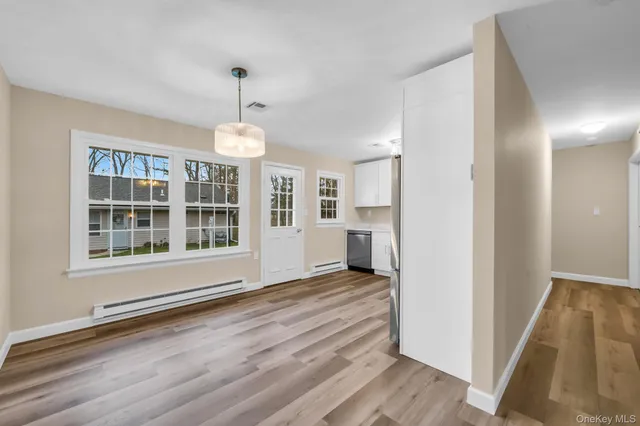 a view of wooden floor and a chandelier in a room