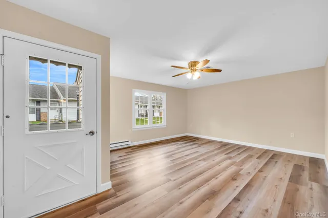 wooden floor in an empty room with a window