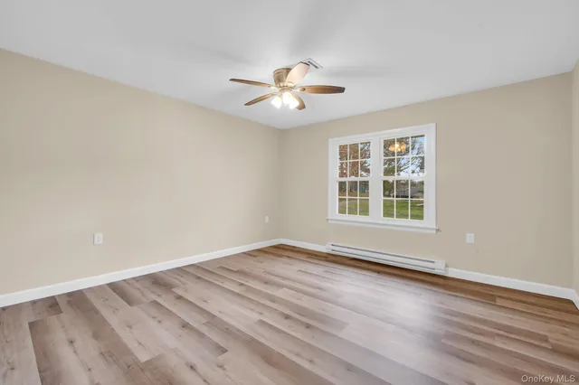wooden floor in an empty room with a window