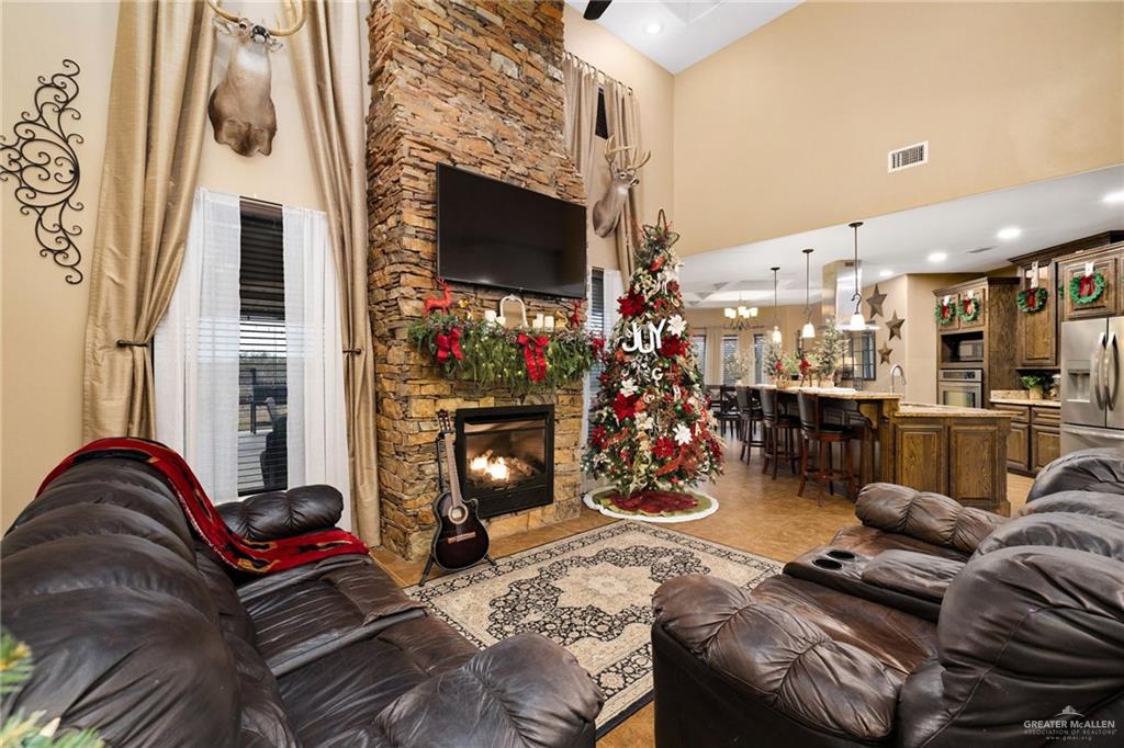 826 Coyote Drive Rio Grande City, TX 78582 - Photo 6 of 10 a living room with furniture a flat screen tv and a fireplace