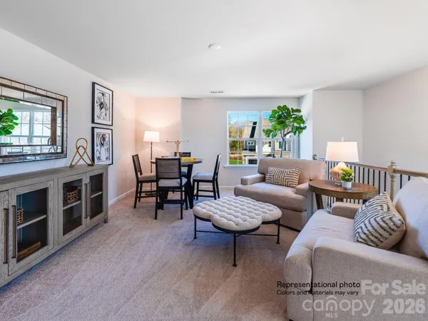 a living room with furniture and a floor to ceiling window