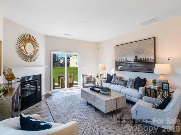 a living room with furniture and painting on wall