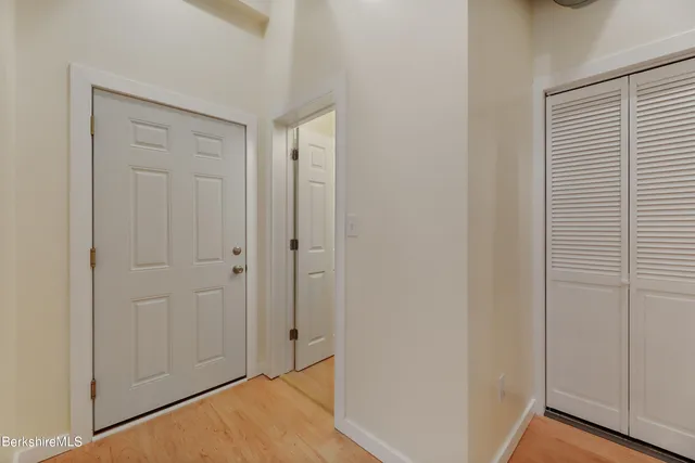 a view of a hallway with wooden floor