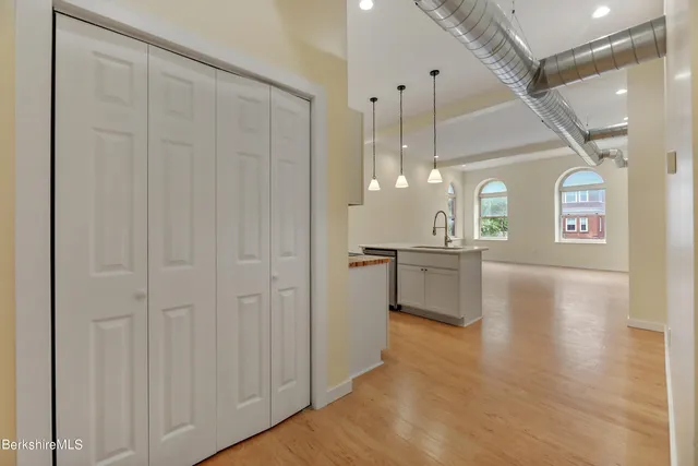 a view of a kitchen with a refrigerator and a stove top oven