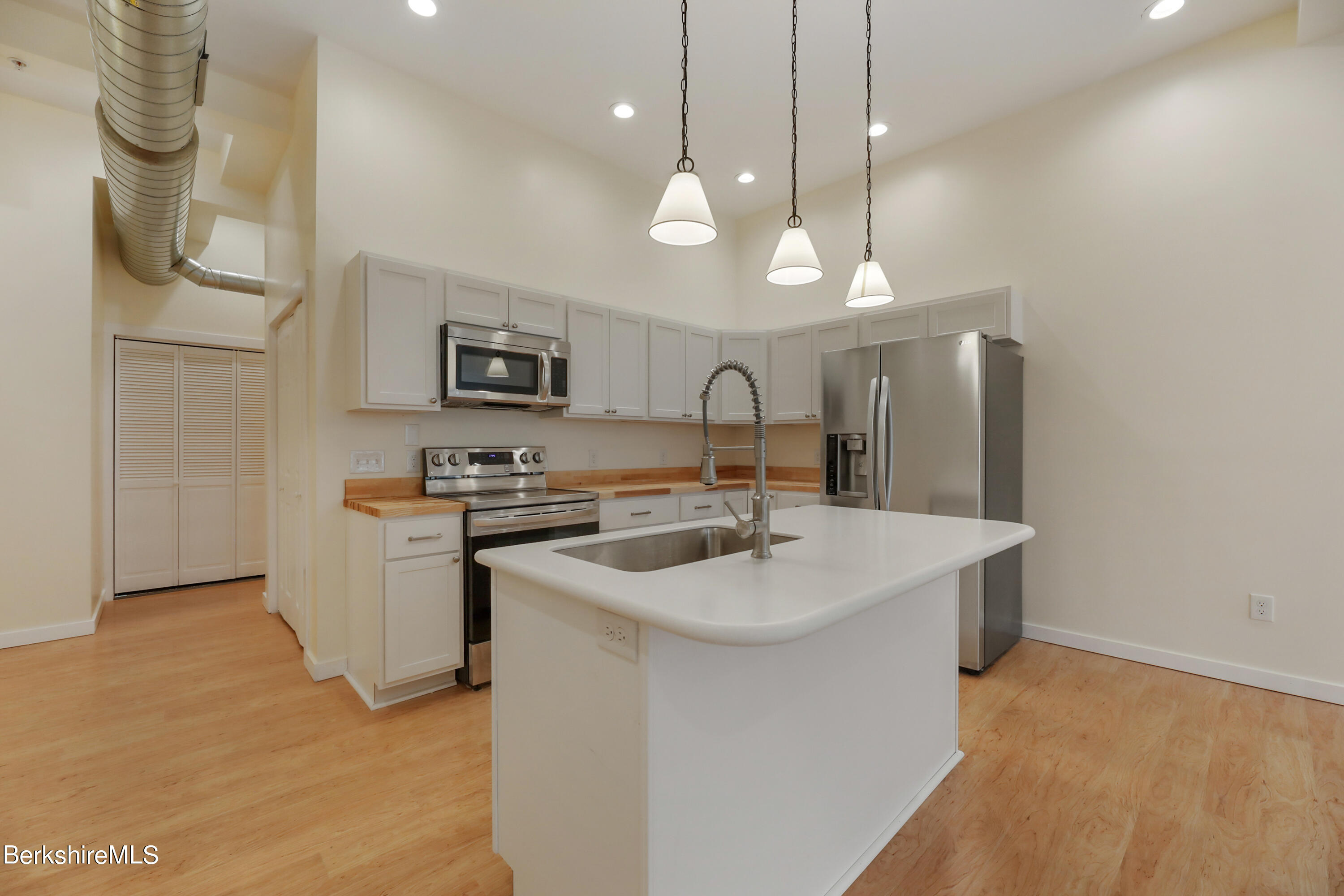 49 Park Street, Unit 3 Adams, MA 01220 - Photo 4 of 14 a kitchen with a sink a counter space appliances and cabinets