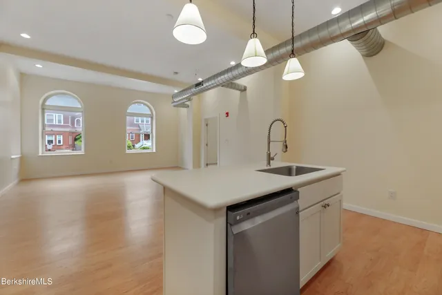 a kitchen with a sink and chandelier