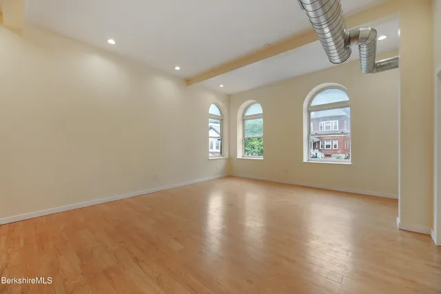 wooden floor in a hall with a window