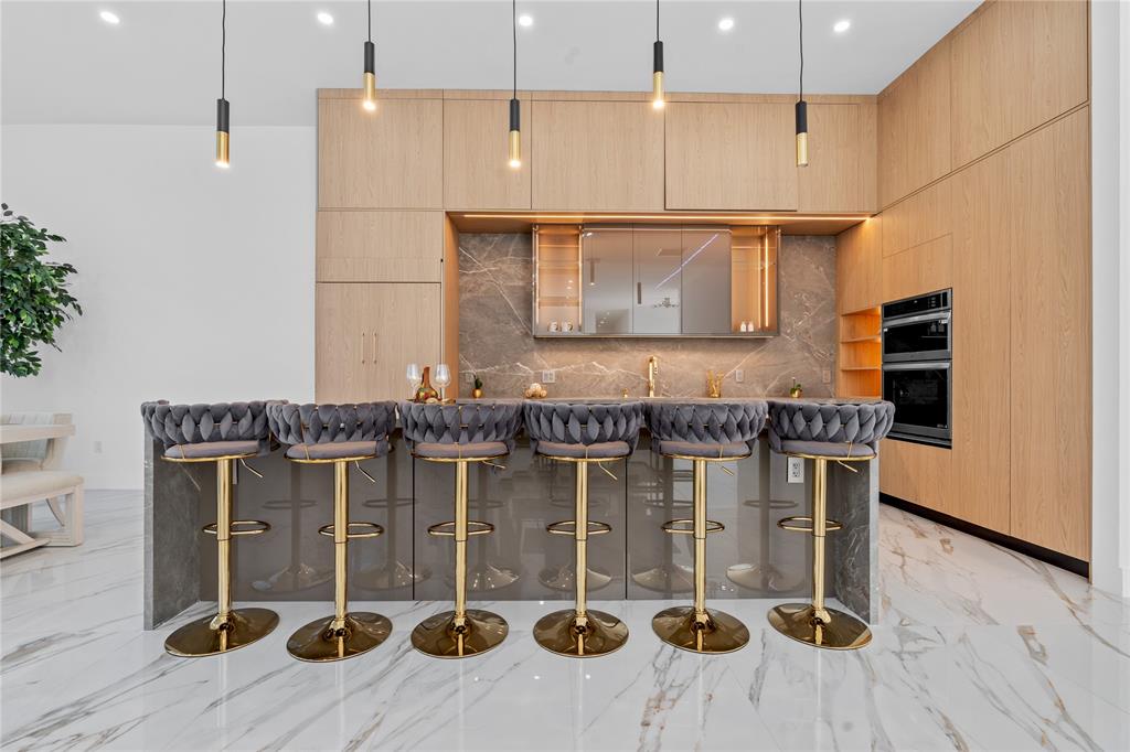 7141 Mariana Court Boca Raton, FL 33433 - Photo 20 of 68 a kitchen with stainless steel appliances kitchen island granite countertop a table and chairs