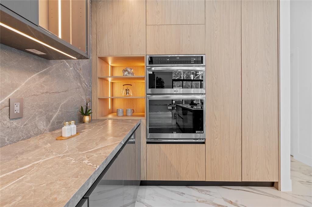 7141 Mariana Court Boca Raton, FL 33433 - Photo 26 of 68 a kitchen with stainless steel appliances granite countertop a stove and a microwave