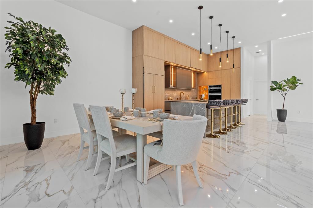 7141 Mariana Court Boca Raton, FL 33433 - Photo 29 of 68 a kitchen with a table and chairs in it