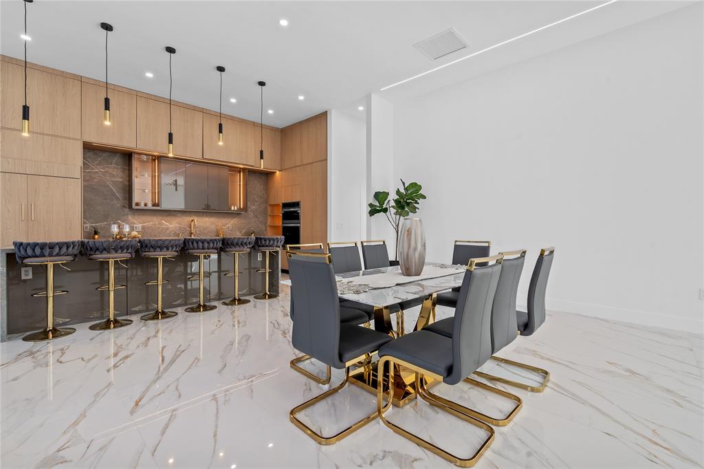 7141 Mariana Court Boca Raton, FL 33433 - Photo 31 of 68 a view of kitchen with kitchen island dining table and chairs