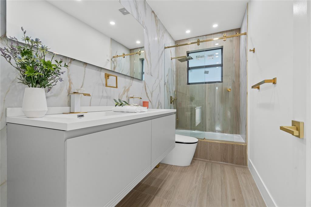 7141 Mariana Court Boca Raton, FL 33433 - Photo 38 of 68 a bathroom with a sink a toilet and shower