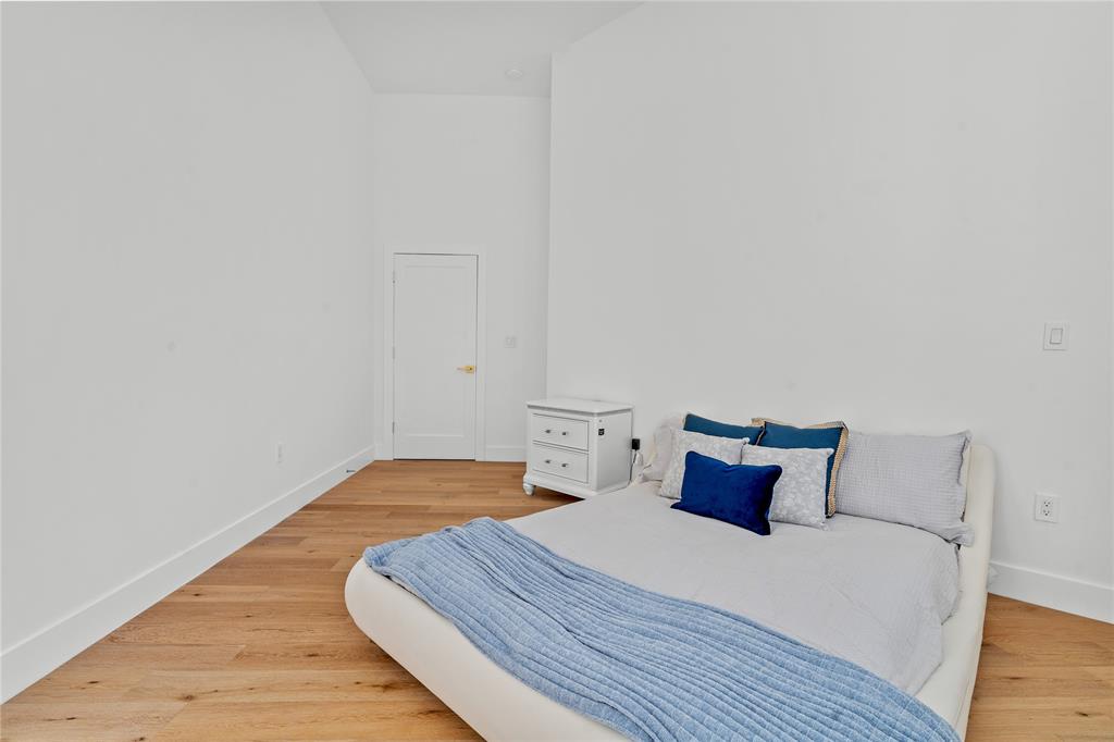 7141 Mariana Court Boca Raton, FL 33433 - Photo 39 of 68 a bedroom with a bed and wooden floor