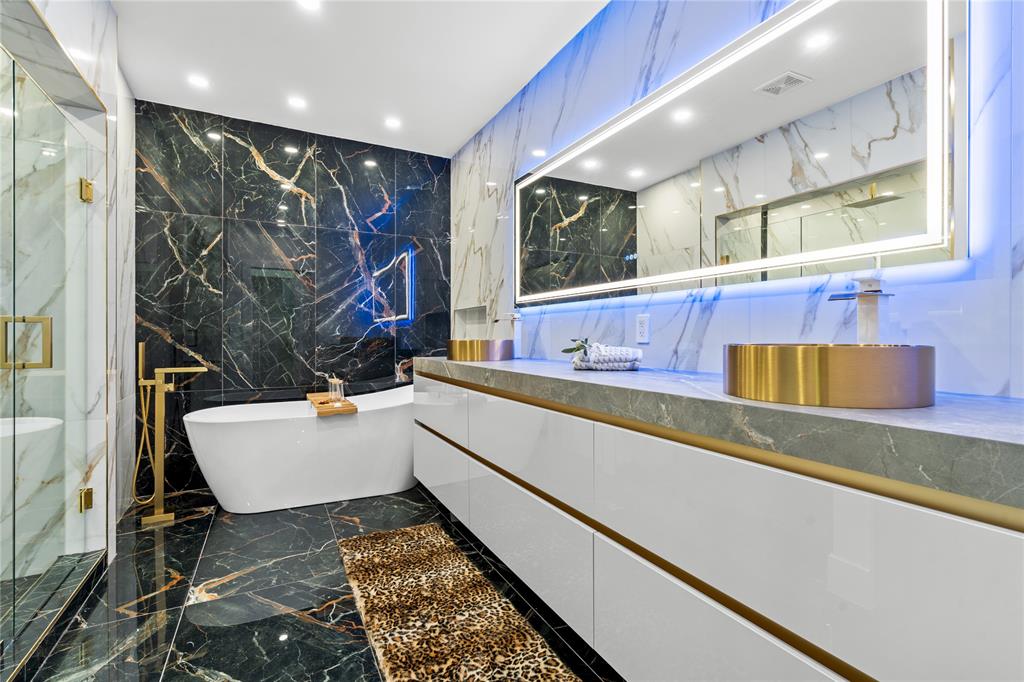 7141 Mariana Court Boca Raton, FL 33433 - Photo 44 of 68 a bathroom with a bathtub and a double vanity sink