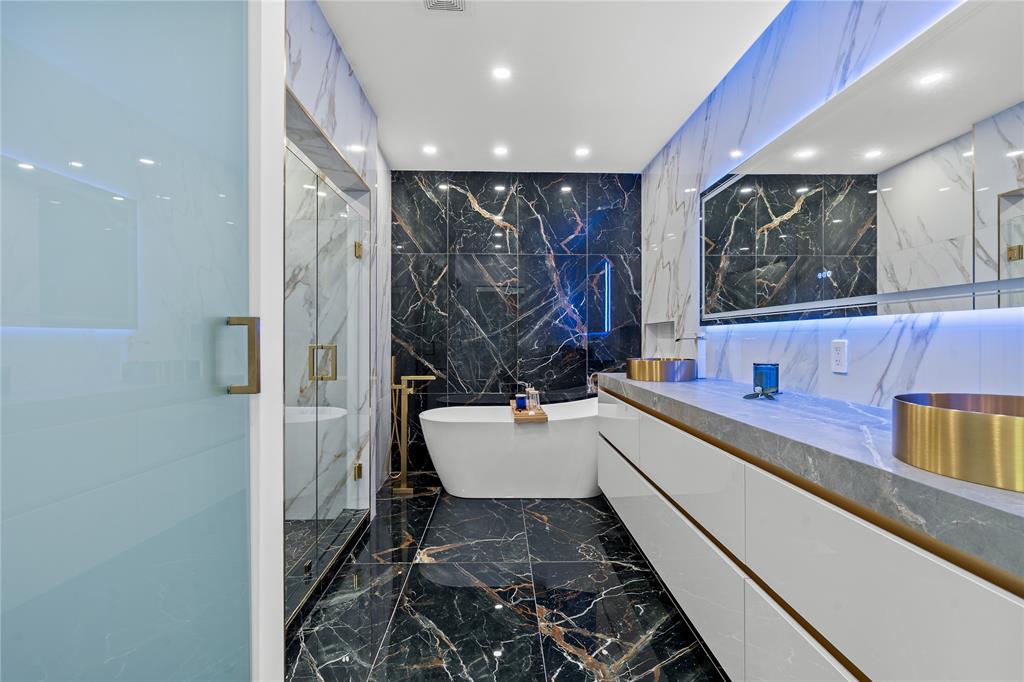 7141 Mariana Court Boca Raton, FL 33433 - Photo 46 of 68 a bathroom with a bathtub and a double vanity sink