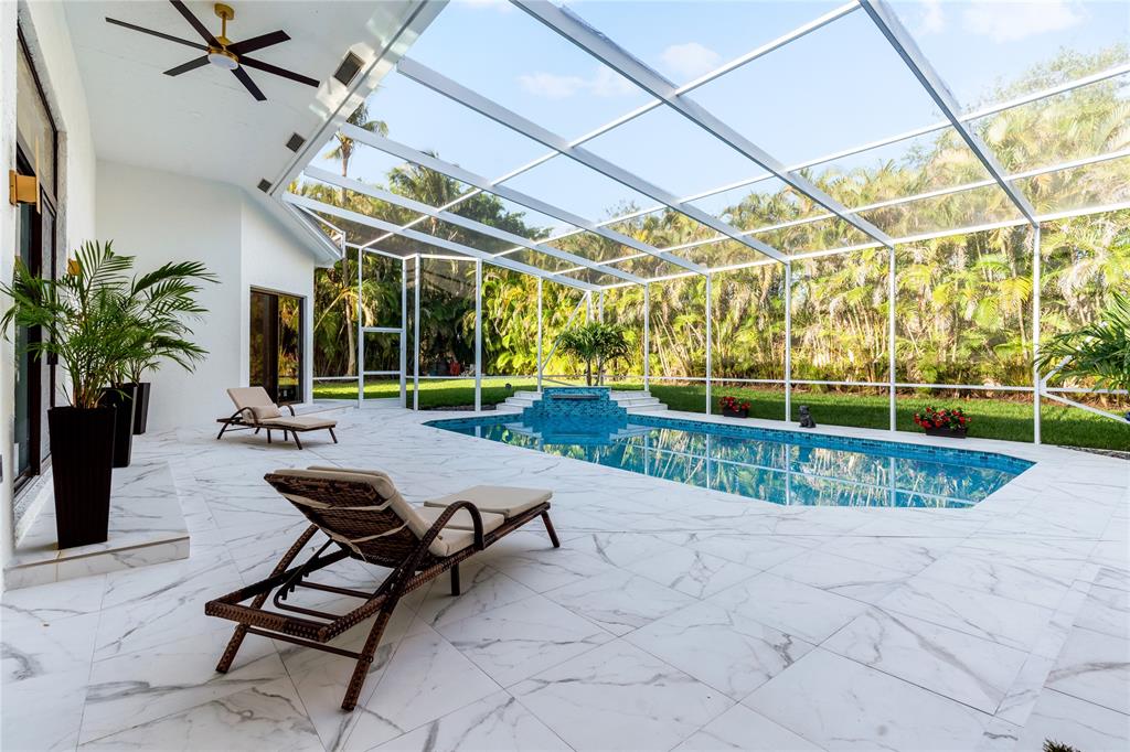 7141 Mariana Court Boca Raton, FL 33433 - Photo 61 of 68 a view of a swimming pool with a patio and a yard