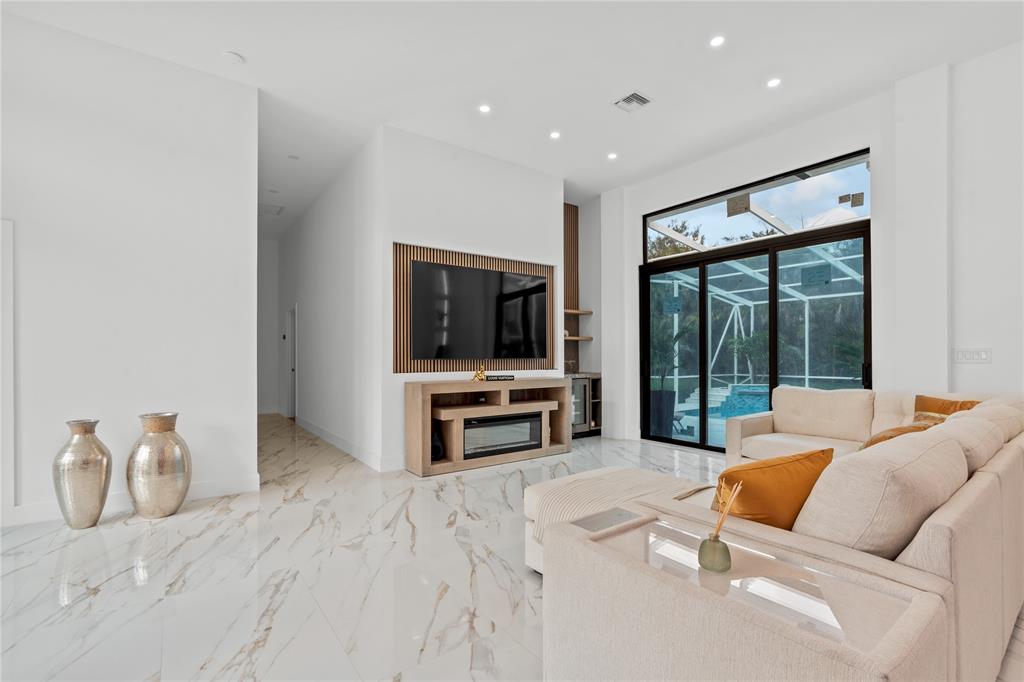 7141 Mariana Court Boca Raton, FL 33433 - Photo 8 of 68 a living room with furniture and a flat screen tv