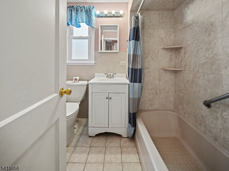 544 Goffle Hill Road Hawthorne, NJ 07506 - Photo 11 of 21 a bathroom with a sink a toilet and shower