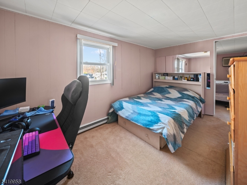 544 Goffle Hill Road Hawthorne, NJ 07506 - Photo 14 of 21 a bedroom with a bed and a window