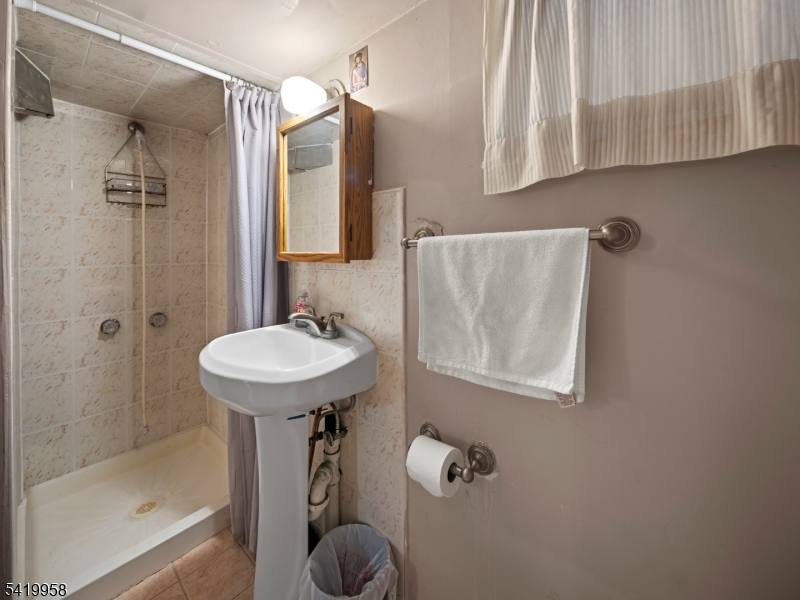 544 Goffle Hill Road Hawthorne, NJ 07506 - Photo 17 of 21 a bathroom with a sink a toilet and shower