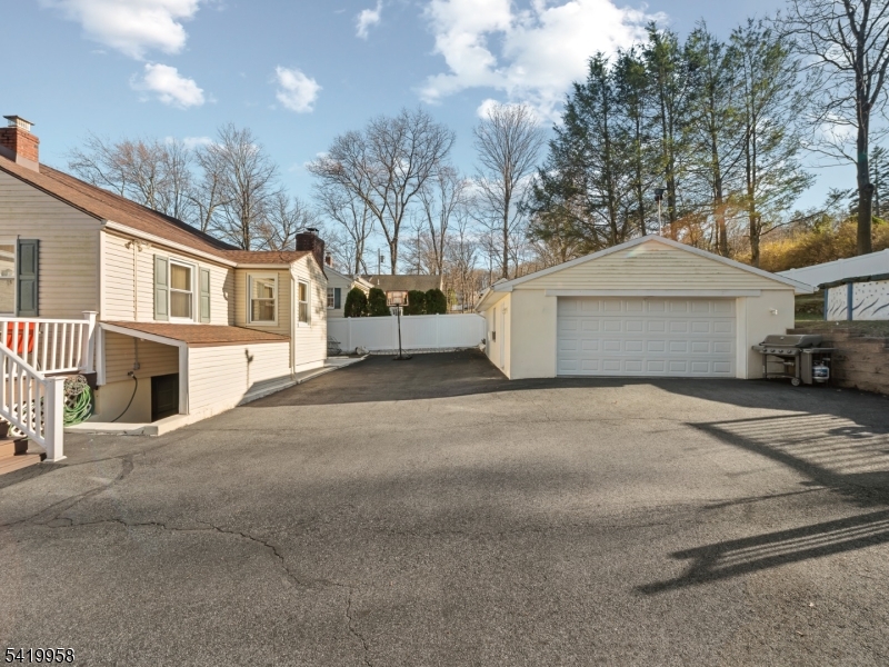 544 Goffle Hill Road Hawthorne, NJ 07506 - Photo 18 of 21 a front view of a house with a yard and garage