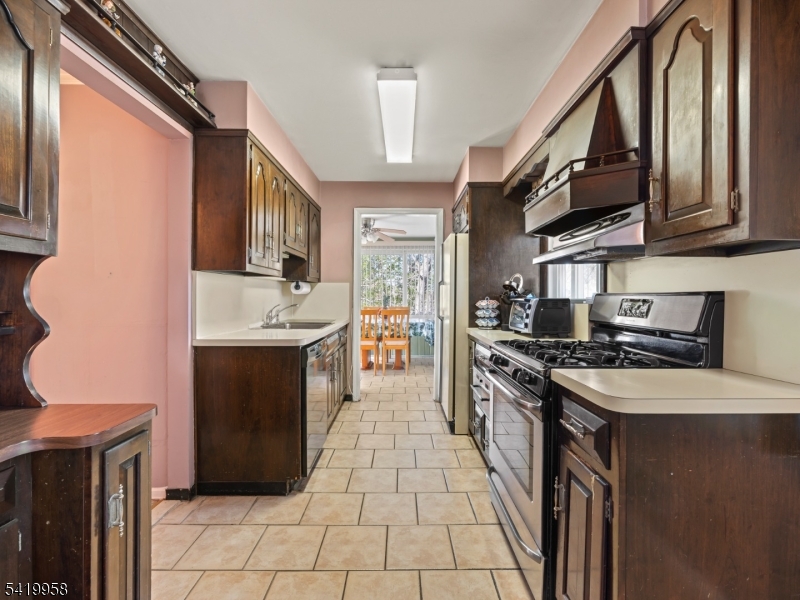544 Goffle Hill Road Hawthorne, NJ 07506 - Photo 5 of 21 a kitchen with stainless steel appliances granite countertop a stove top oven a sink a counter space and cabinets
