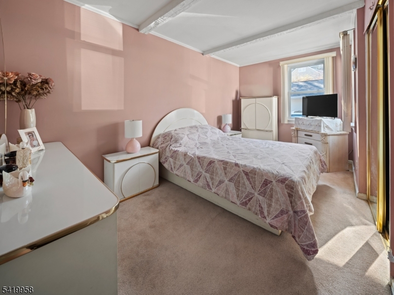 544 Goffle Hill Road Hawthorne, NJ 07506 - Photo 7 of 21 a bedroom with a bed and a flat screen tv