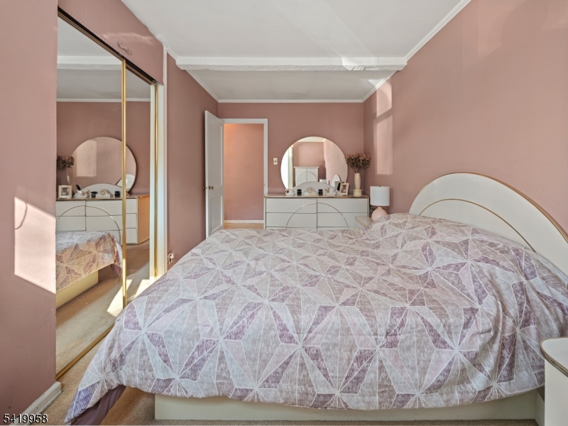 544 Goffle Hill Road Hawthorne, NJ 07506 - Photo 8 of 21 a large bed sitting in a bedroom next to a window