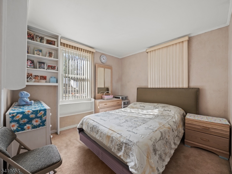 544 Goffle Hill Road Hawthorne, NJ 07506 - Photo 9 of 21 a bedroom with a bed and a couch