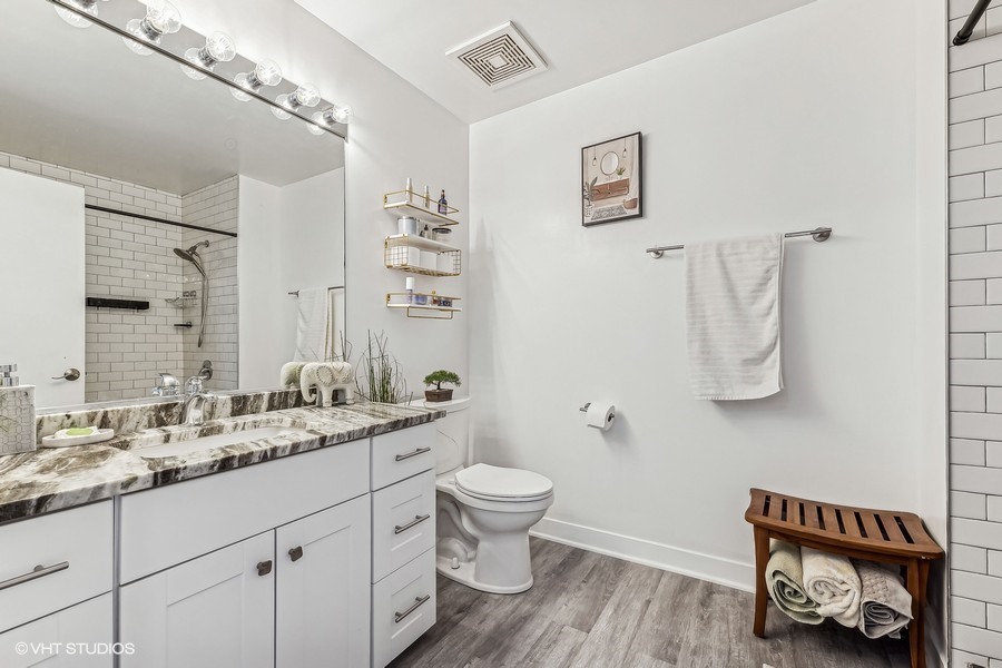 833 West 15th Place, Unit 511 Chicago, IL 60608 - Photo 12 of 16 a bathroom with a sink a toilet and a mirror