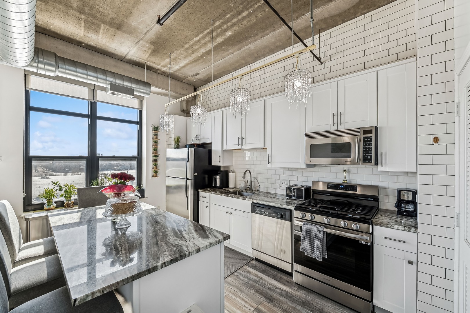 833 West 15th Place, Unit 511 Chicago, IL 60608 - Photo 2 of 16 a kitchen with stainless steel appliances granite countertop a stove refrigerator sink and cabinets